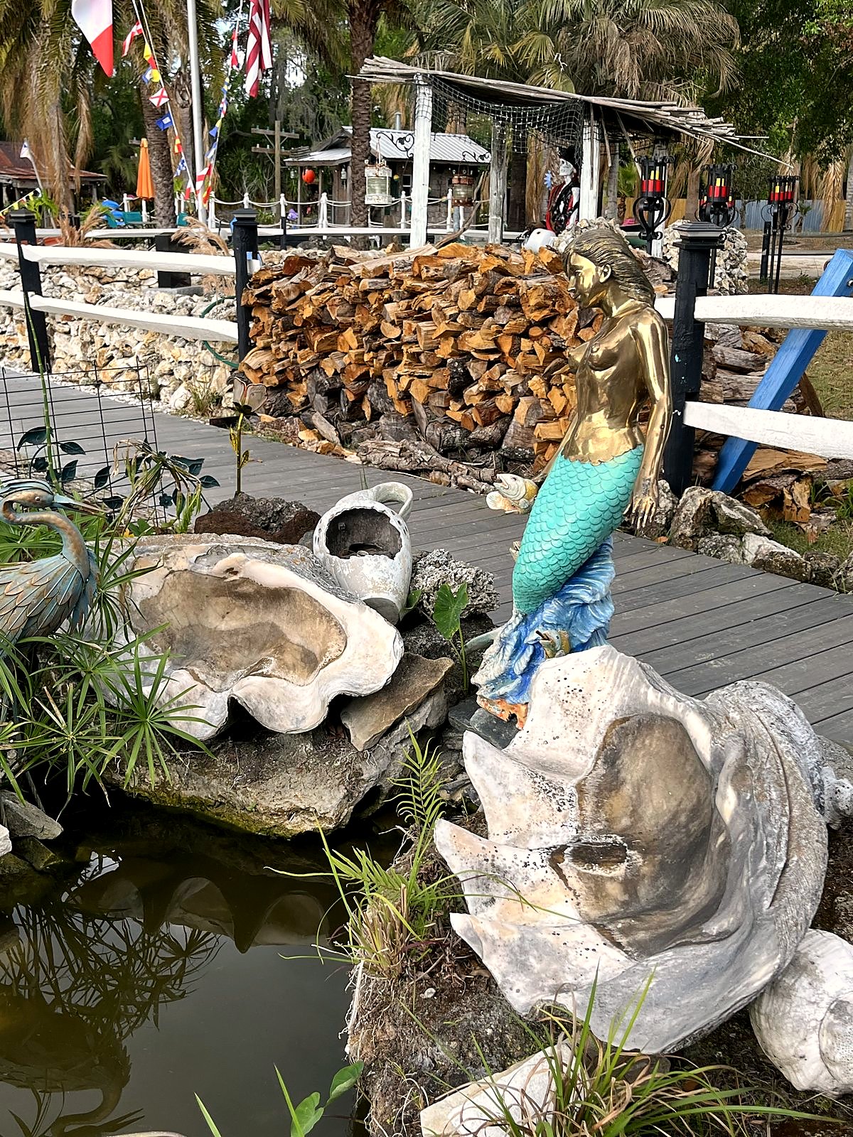 Gold mermaid sculpture in shell fountain